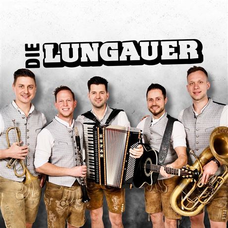 A live band is playing on a stage in the mountains. In the background, there are snow-covered peaks and spectators enjoying the concert.